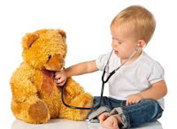 Child holding stethoscope to Teddy